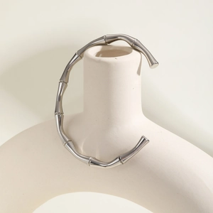 Detailed macro view of silver bamboo-style open cuff bracelet with polished finish