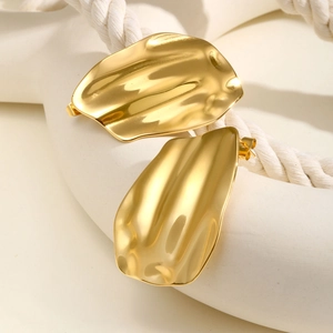 Detailed view of irregular 18K gold-plated stainless steel earrings on a rustic woven rope