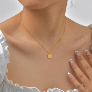 Elegant 18K gold plated stainless steel necklace with geometric woven square pendant on model