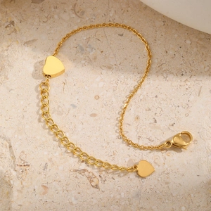 Gold stainless steel heart charm anklet with adjustable chain and lobster clasp on stone