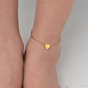 Close-up of a gold heart charm anklet featuring a minimalist flat polished link chain