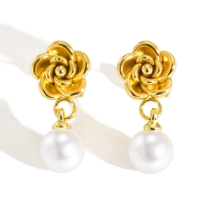 Golden camellia earrings with round white pearl pendants on a clean white background