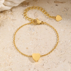 Golden heart charm stainless steel chain anklet with adjustable extension on stone background