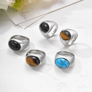 Macro shot of silver men's signet rings with black onyx, tiger eye and turquoise stones