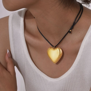 Minimalist 3D hollow heart pendant necklace with polished gold finish and black cord