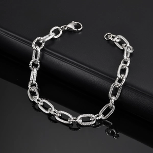 Detail of men's stainless steel chain bracelet with textured links and lobster clasp
