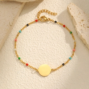 Detail of 18K gold chain bracelet with colorful enamel beads and polished round pendant