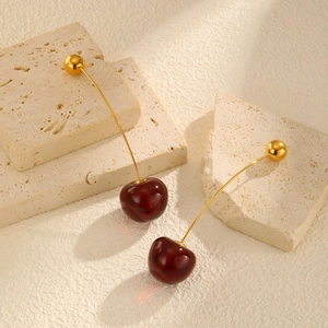 Elegant cherry-shaped earrings featuring red translucent beads and golden stainless steel stems