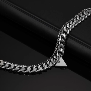 Detail of silver double layer chain with polished triangle pendant on black base