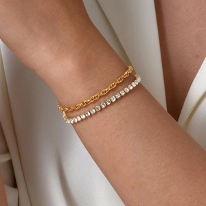 Close-up of a 18K gold plated rope chain and sparkling white zircon tennis bracelet set