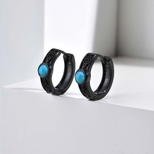 Detail of black Celtic knot hoop earrings with turquoise inlay on white display