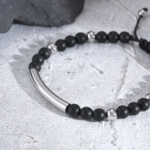 Men's matte black beaded bracelet with stainless steel curved tube and adjustable cord