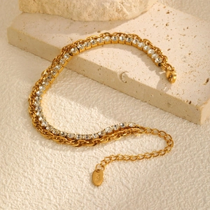 Detail of 18K gold double-layer bracelet with sparkling zircons and twisted chain links