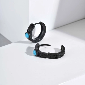 Detailed macro view of black stainless steel Celtic knot hoop earrings with turquoise stone