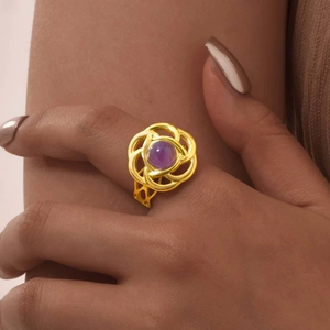 Anello a fiore intrecciato in oro 18 carati con cristallo viola indossato sulla mano
