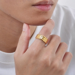 Detail of gold triple-layered stainless steel ring with a rectangular cubic zirconia