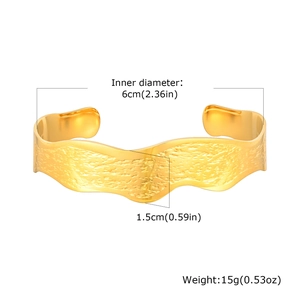 Golden wavy stainless steel C-shaped cuff bracelet with a hammered texture finish