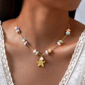 Detailed close-up of a golden starfish necklace with pearls and colorful seashells on a model