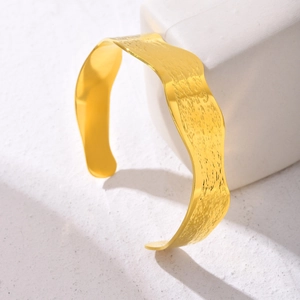 Gold-plated stainless steel cuff bracelet with hammered texture and wavy edges