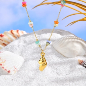 Golden shell necklace with vibrant colorful stone beads on a summer beach background