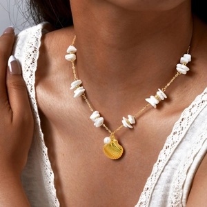 Golden seashell pendant necklace with white pearl and shell beads on a model