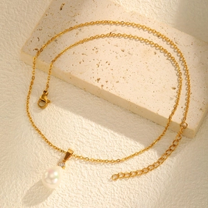 Vintage gold stainless steel necklace with teardrop pearl and zircon pendant on stone