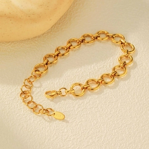 Close-up of 18K gold-plated interlocking circular link bracelet with K18 tag and lobster clasp