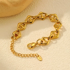 Detailed view of K18 engraved tag on gold-tone geometric rhombus link chain bracelet