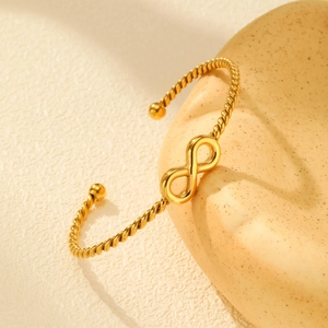Macro shot of 18K gold plated infinity twisted rope bracelet with a smooth polished finish