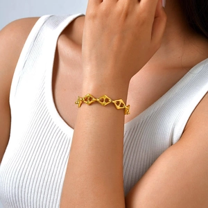 Minimalist geometric hollow diamond link bracelet in gold finish worn on female wrist