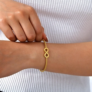 18K gold plated infinity rope cuff bracelet on female wrist with white sweater