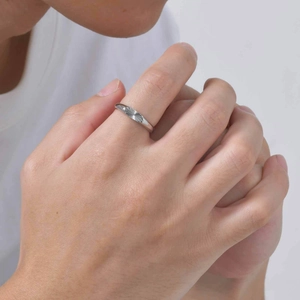 Polished silver stainless steel ring featuring a sunburst oval engraved pattern on hand