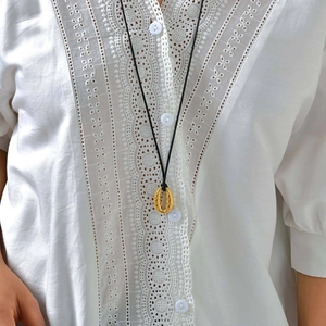 Elegant gold oval pendant necklace with embossed fish scale pattern on black cord