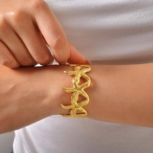 Detailed close-up of golden starfish open cuff bracelet with realistic textures on wrist