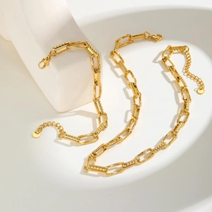 Detail of gold rectangle link necklace and bracelet with diamond-cut texture finish