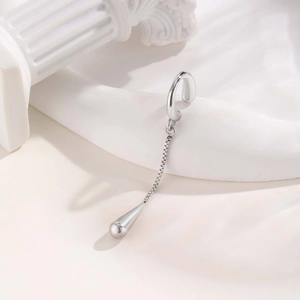 Detailed view of silver stainless steel ear cuff featuring a chain and polished teardrop pendant