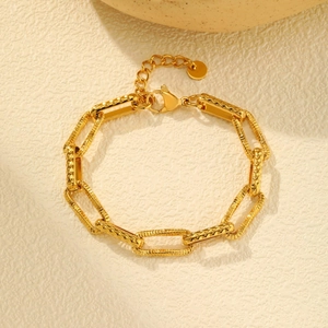Detail of gold textured link bracelet with diamond pattern and lobster clasp closure