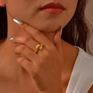 Minimalist 18K gold-plated open hug ring with a fluid streamlined design on a hand