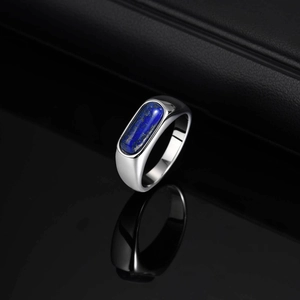 Polished stainless steel signet ring for men featuring an oval blue lapis lazuli stone