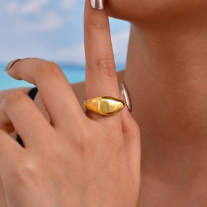 Close-up of a minimalist 18K gold plated stainless steel teardrop ring on a model hand