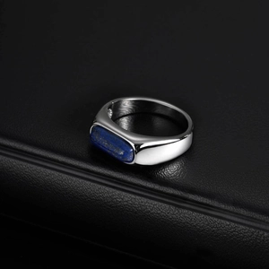 Macro shot of polished silver steel ring featuring an inlaid rectangular lapis lazuli stone
