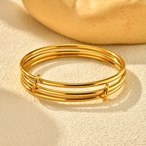 Polished gold triple-layered interlocking stainless steel bangle with adjustable design