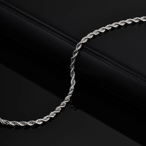 Detailed macro view of silver stainless steel rope chain texture on black background