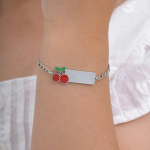 Detail of child's stainless steel bracelet with cherry charm and engravable ID plate