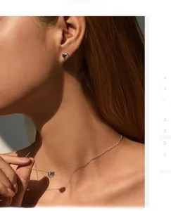Elegant S925 silver heart necklace and earrings set with pavé cubic zirconia on model
