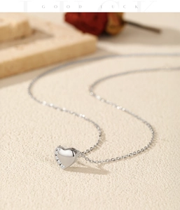 Macro view of polished S925 silver heart pendant necklace with shimmering zircon accents