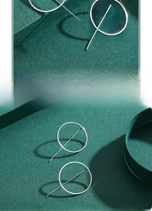 Macro detail of geometric S925 sterling silver earrings with circular and bar design