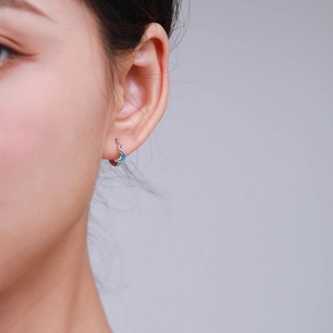 Elegant S925 sterling silver hoop earrings with a small light blue crescent moon charm