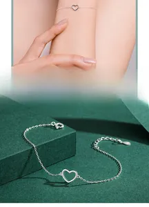 Detail of delicate S925 sterling silver heart bracelet with adjustable chain on wrist
