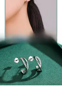 Close-up of S925 sterling silver geometric C-shape stud earrings with pavé micro-zirconia
